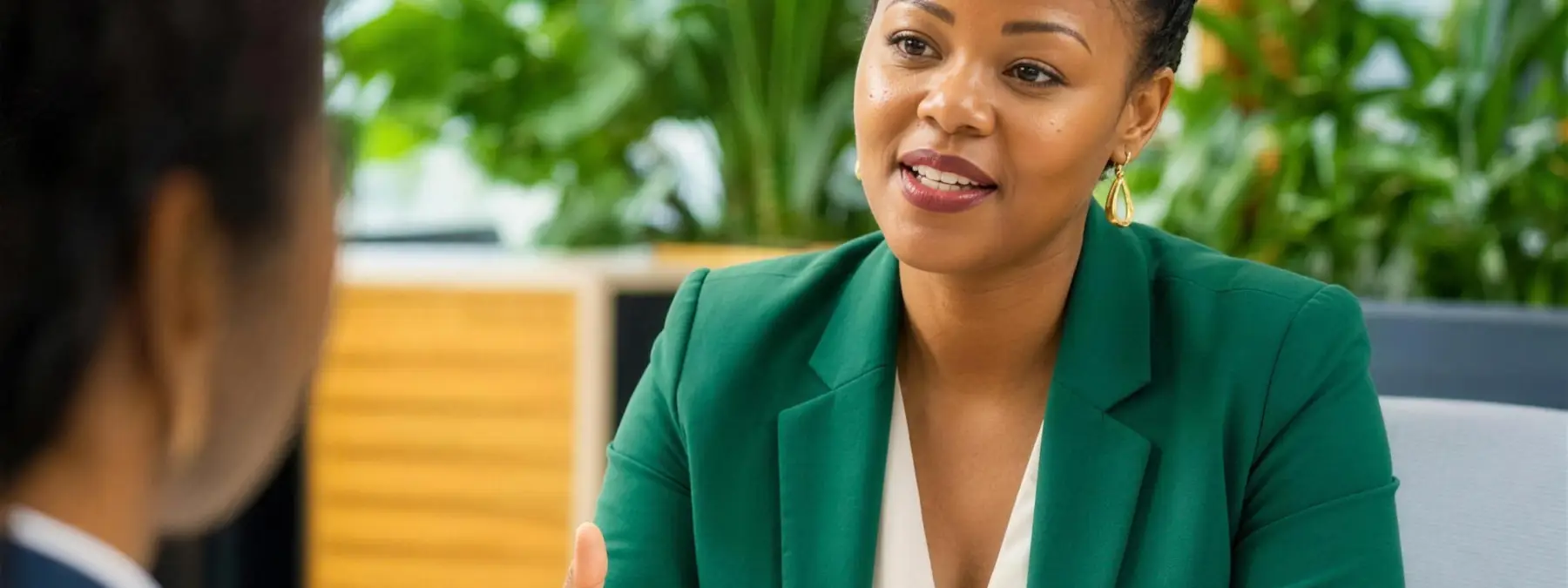 A candidate listening across the table during a professional interview